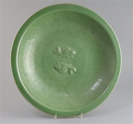 A Chinese celadon glazed twin fish dish, Qing dynasty, D. 34.5cm, wood stand